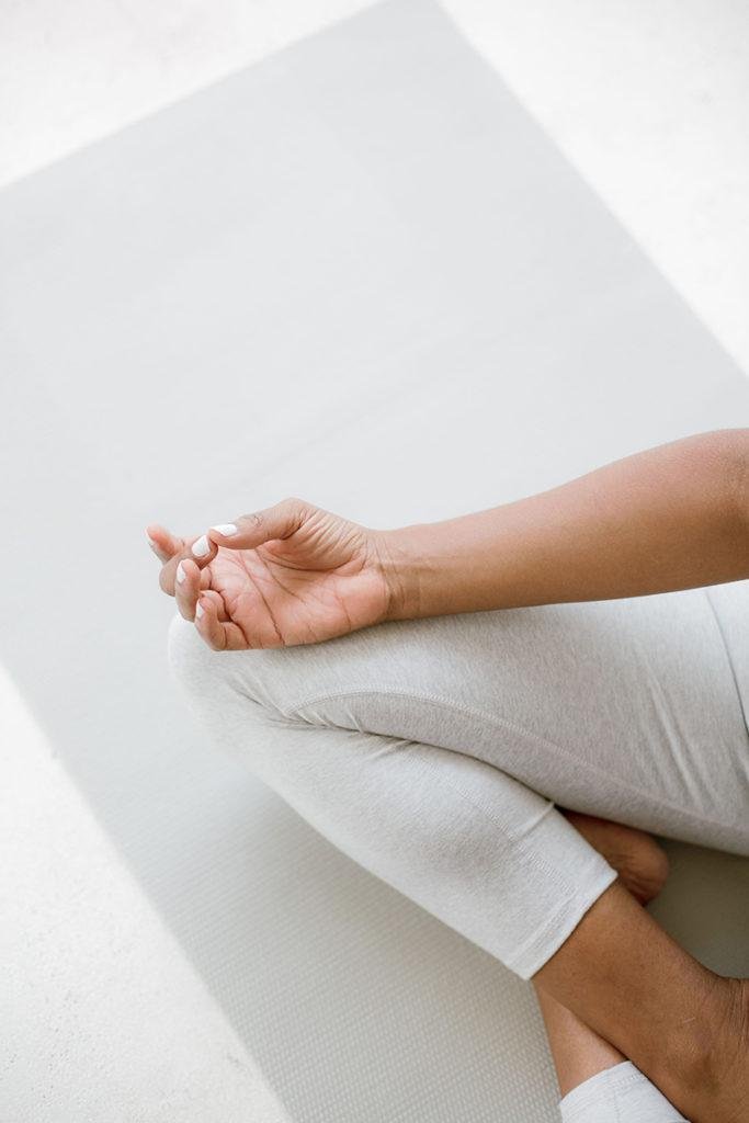 a woman on a yoga mat in the easy seat