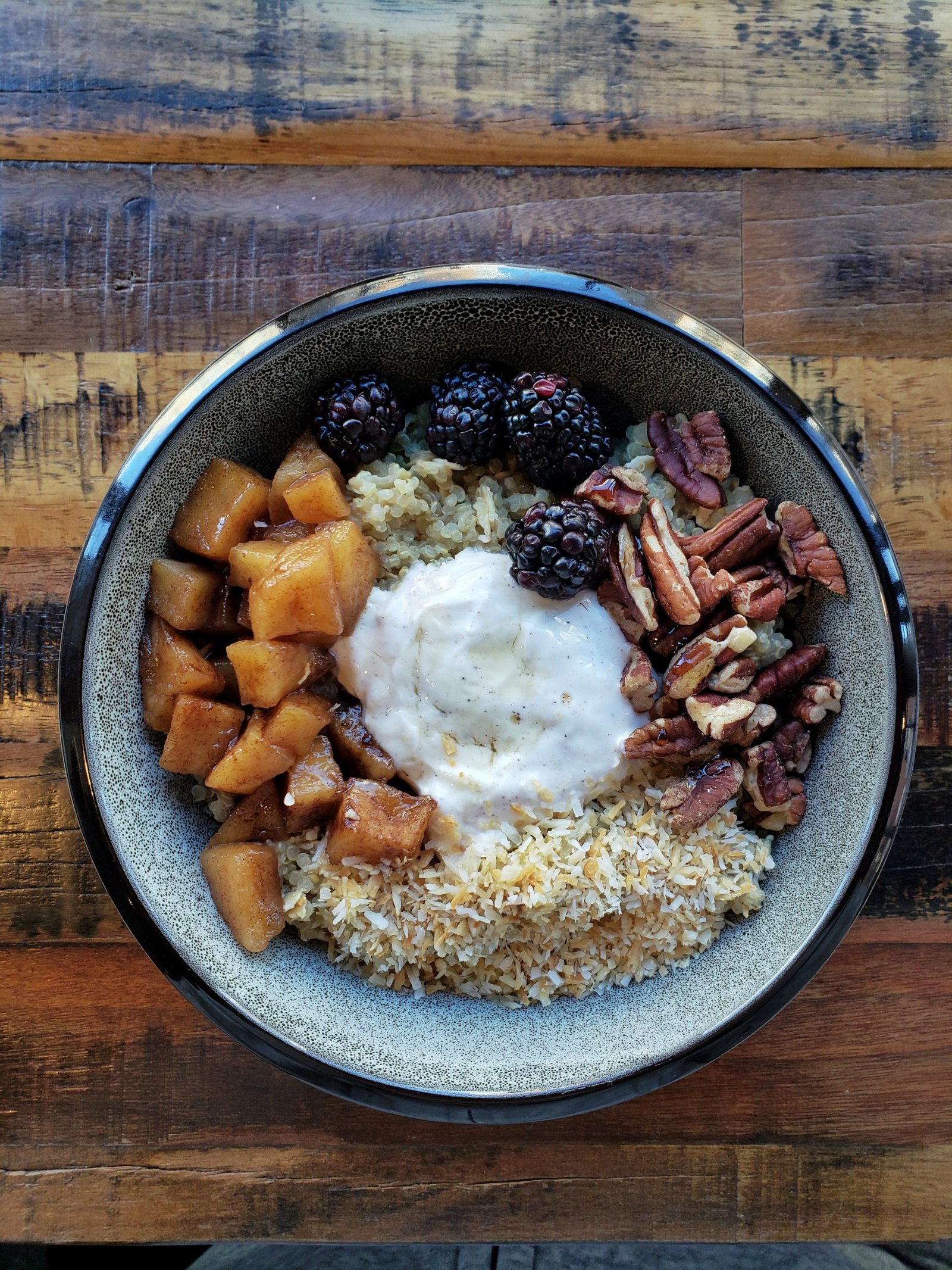 coconut quinoa porridge bowl with seasonal fruit at Kaldi's Social House in Arlington, VA