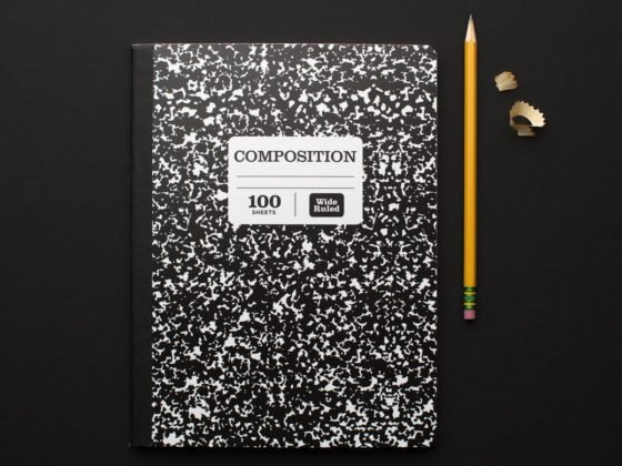 composition notebook with yellow pencil